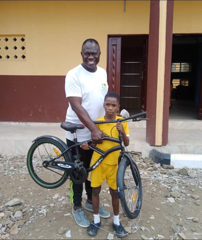 ORILE AGEGE LCDA CHAIRMAN RECIPROCATES, PRESENTS BICYCLE TO 10 YEAR-OLD PUPIL